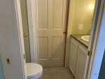 Sink and toilet behind another pocket door off laundry and tub room